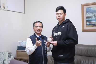 台中捷運公司副總經理葉進財代表盧秀燕市長致贈中華隊投手陳冠偉（右）終身榮譽卡及小綠綠抱枕