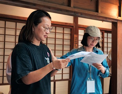 學員在林之助紀念館中手持《孔雀咖啡廳》劇本進行讀劇