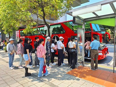 民眾於捷運松竹站旁搭乘漢神洲際免費接駁車。